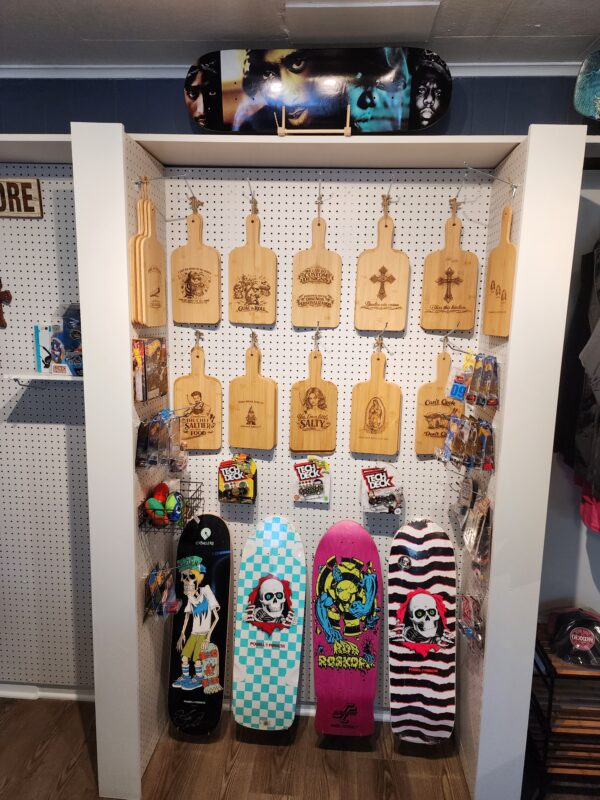 Engraved cutting boards and colorful skateboard decks displayed at HodgePodge in North Austin