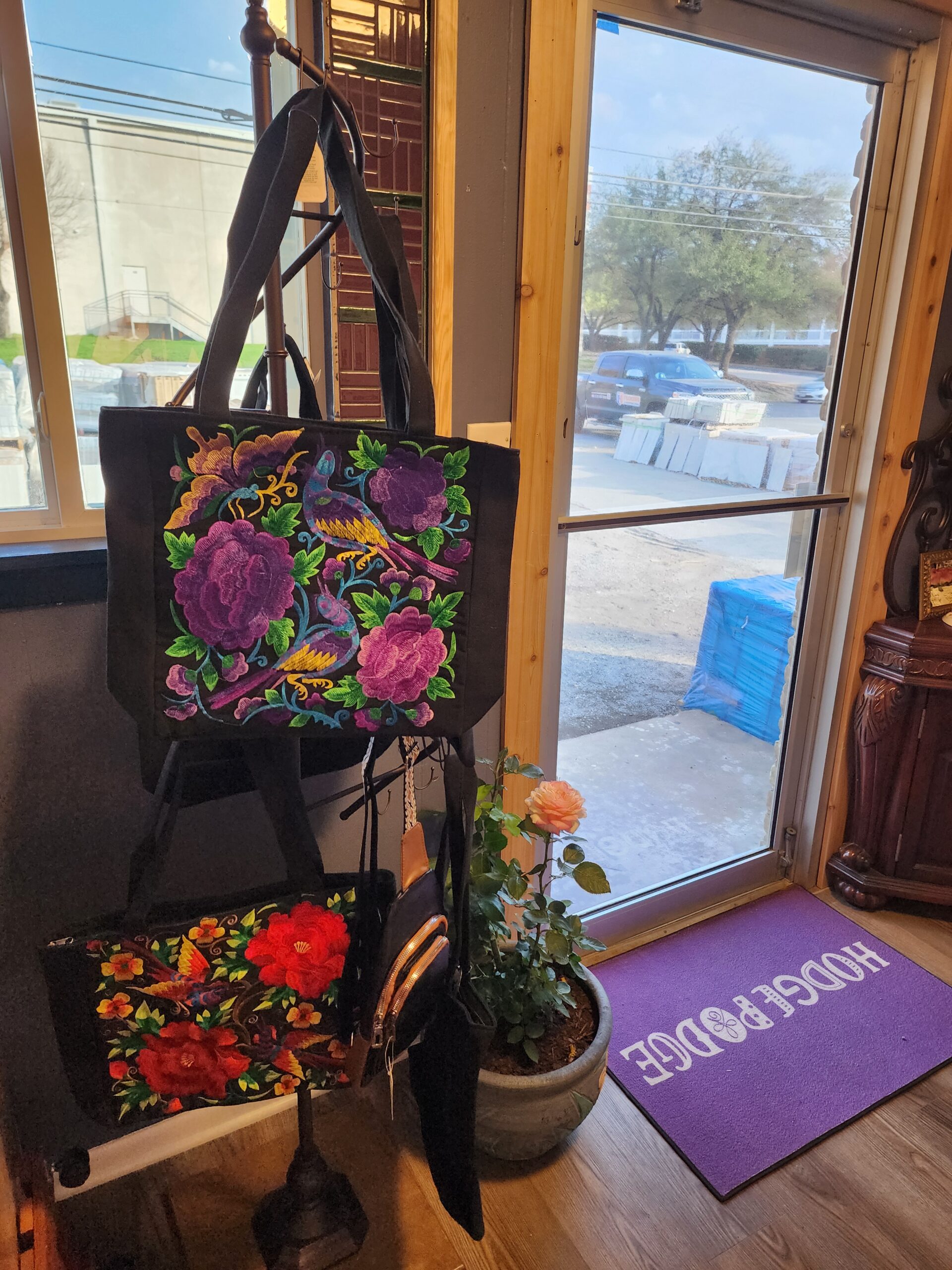 A floor stand display with floral tote bags