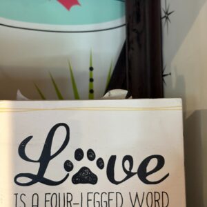 Love is a four legged word sign