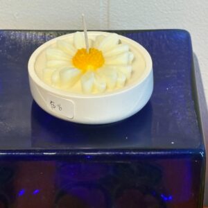 chamomile candle in round dish