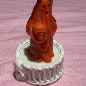 Ghost holding a skull Halloween candle