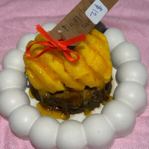 Pineapple on a cake candle in round dish